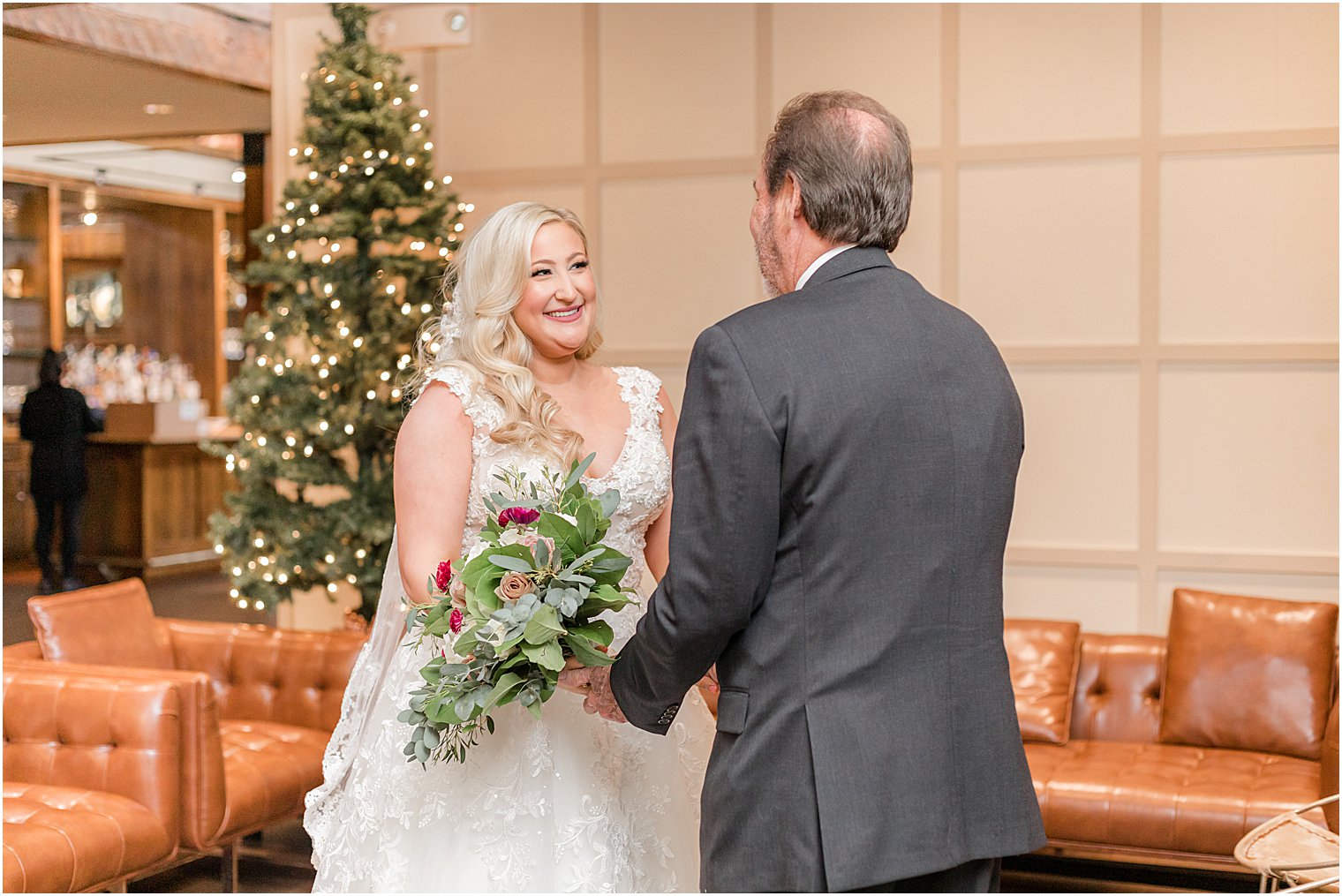 bride smiles at father during first look at Stone House at Stirling Ridge