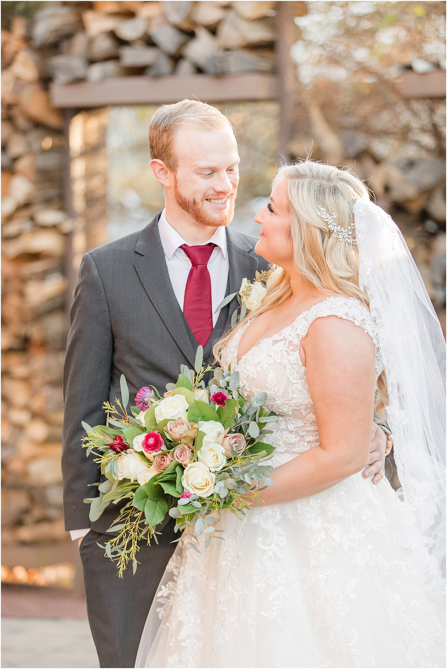 bride looks at groom during portraits at Stone House at Stirling Ridge