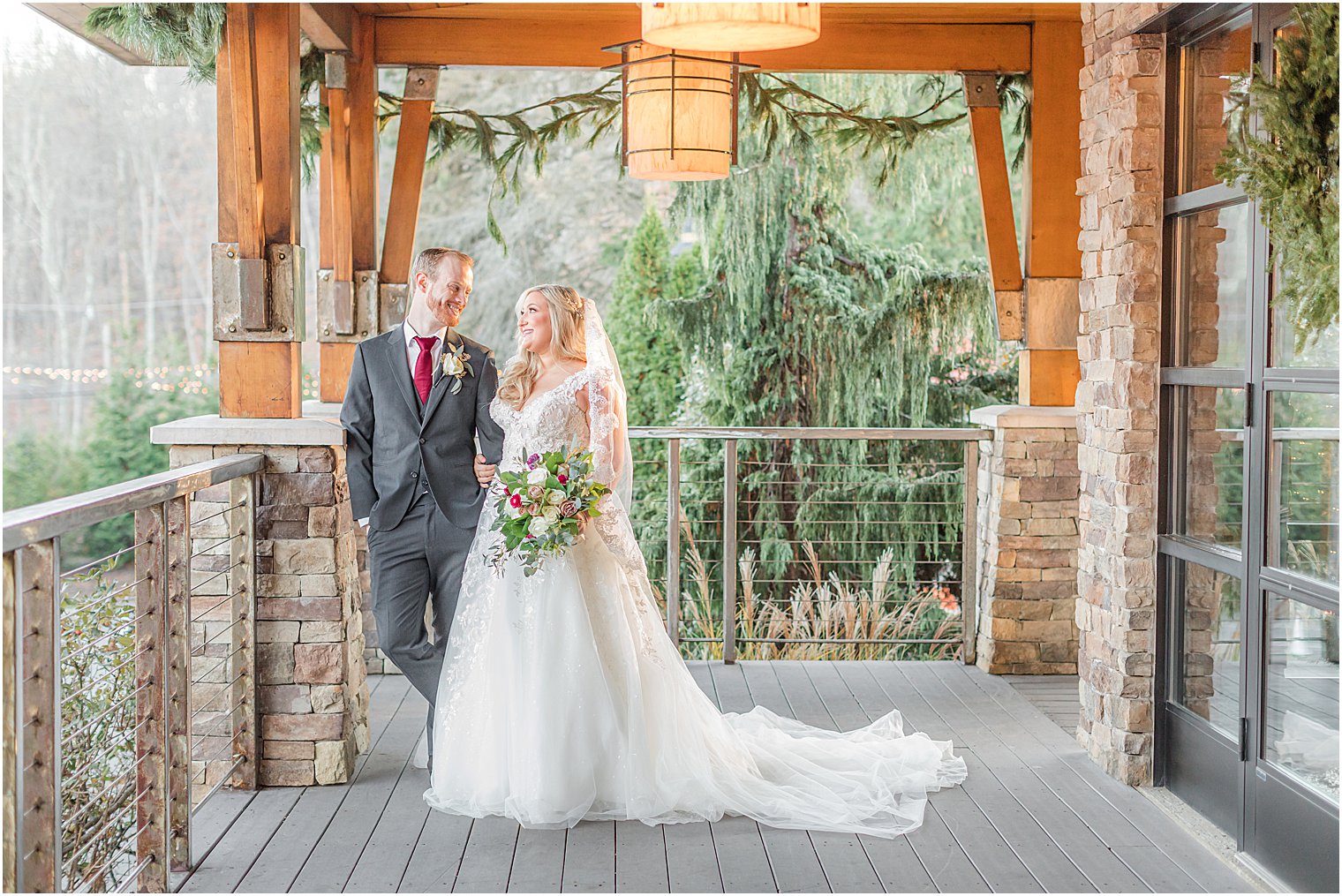 bride and groom pose on balcony at Stone House at Stirling Ridge