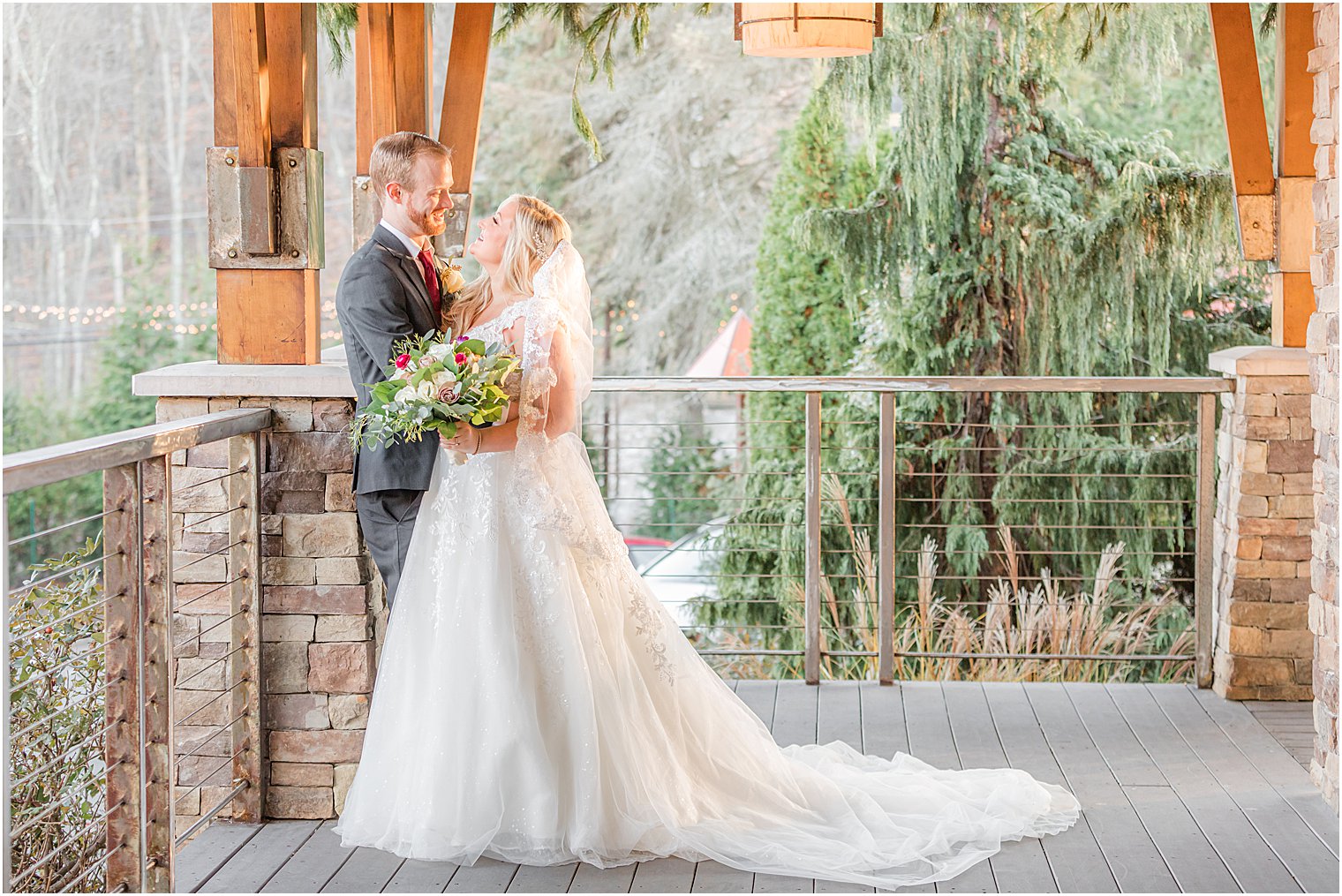 bride and groom pose on balcony at Stone House at Stirling Ridge