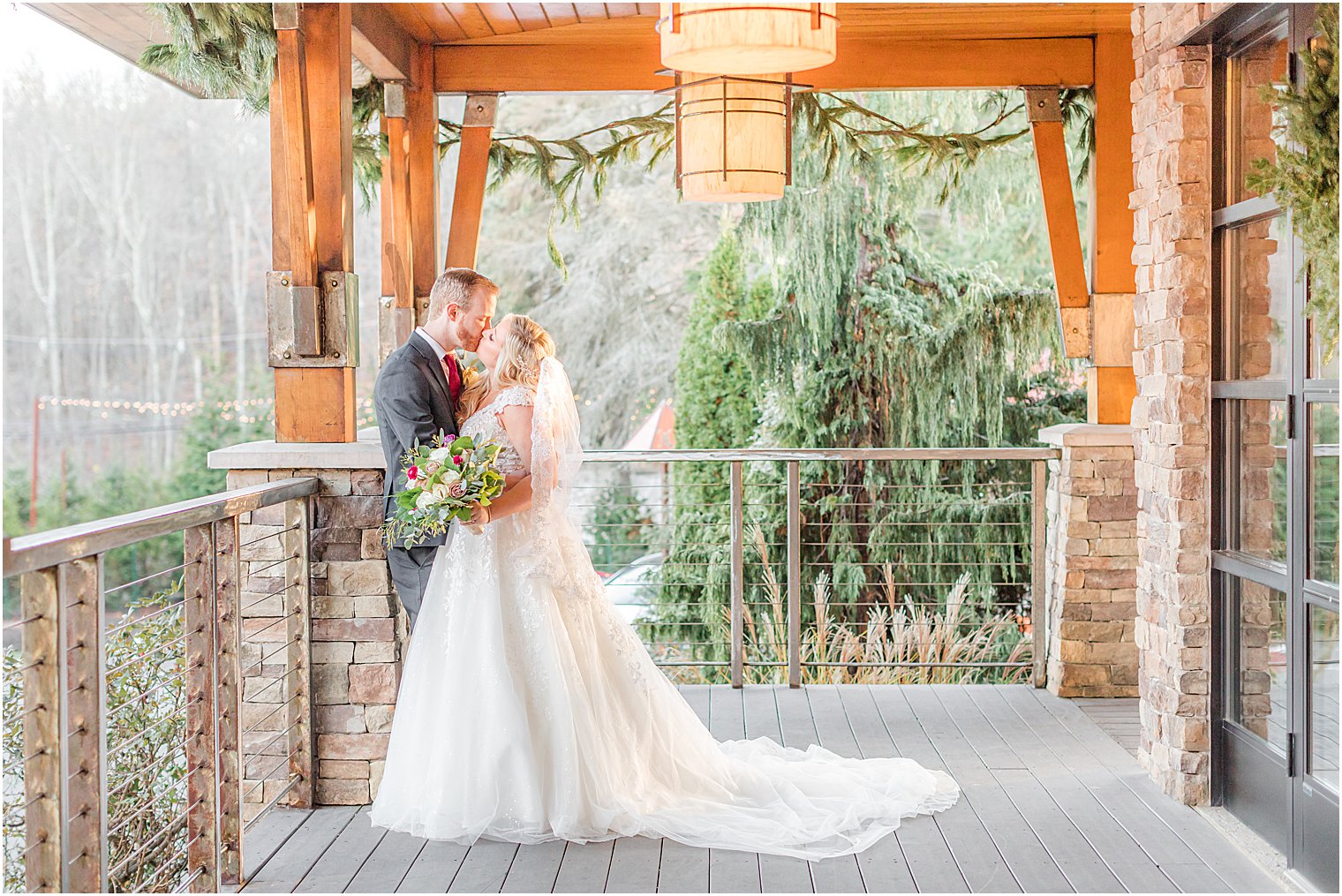 bride looks up at groom on balcony at Stone House at Stirling Ridge