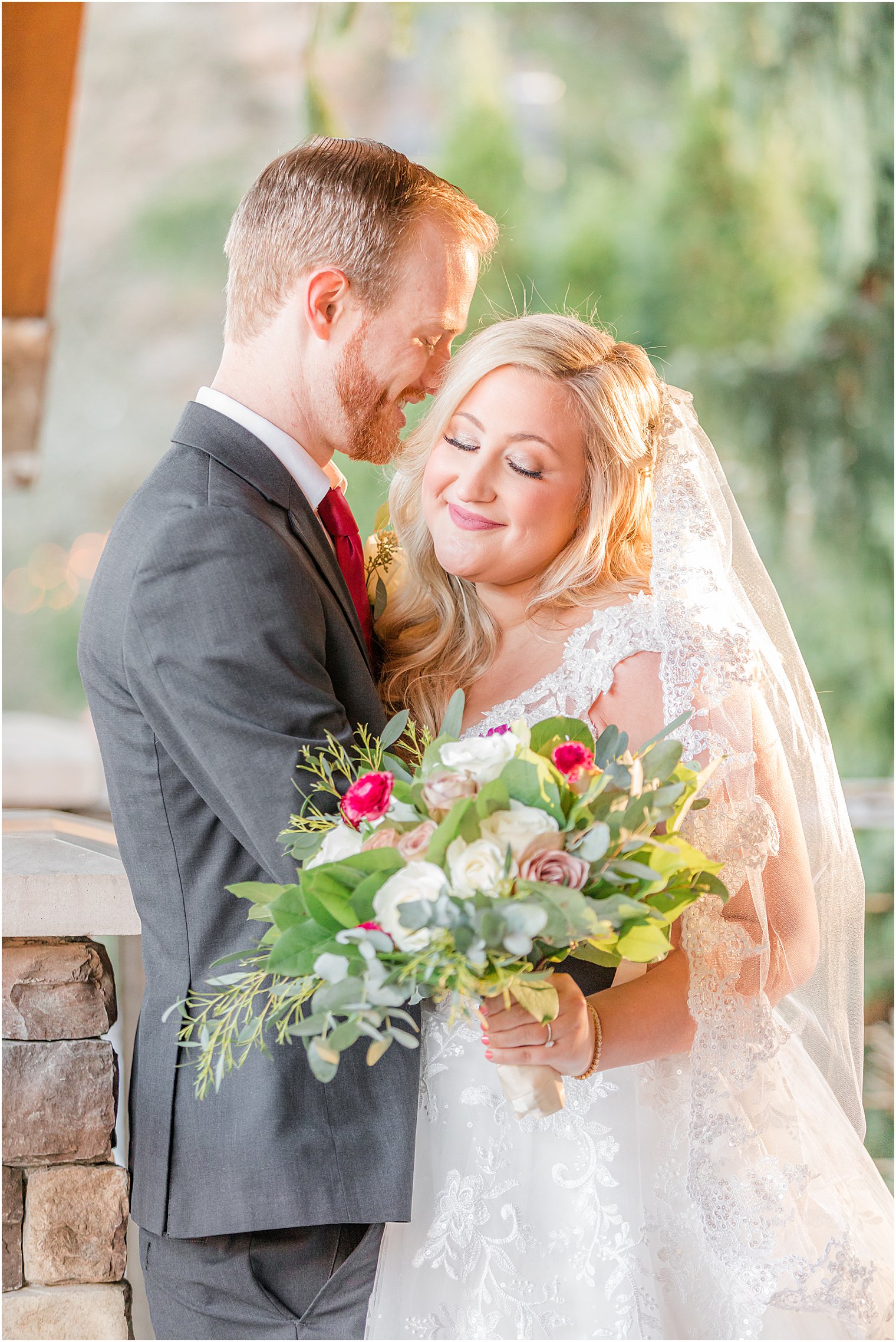 groom kisses bride's cheek during portraits at Stone House at Stirling Ridge