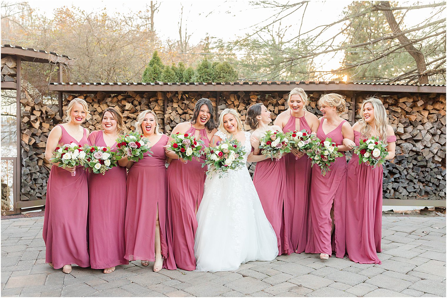 bride laughs with bridesmaids during portraits at Stone House at Stirling Ridge