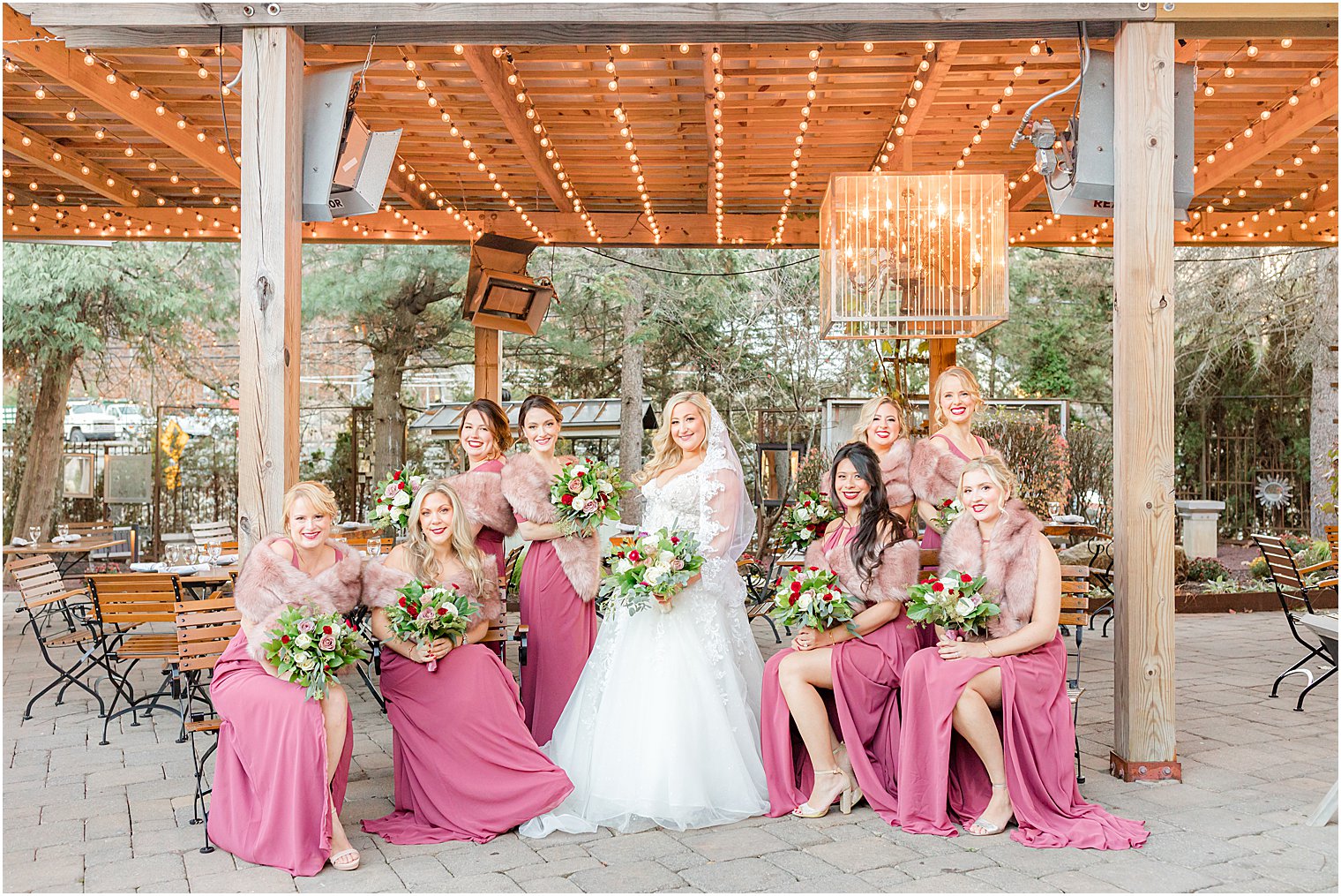 bride and bridesmaids pose on patio at Stone House at Stirling Ridge