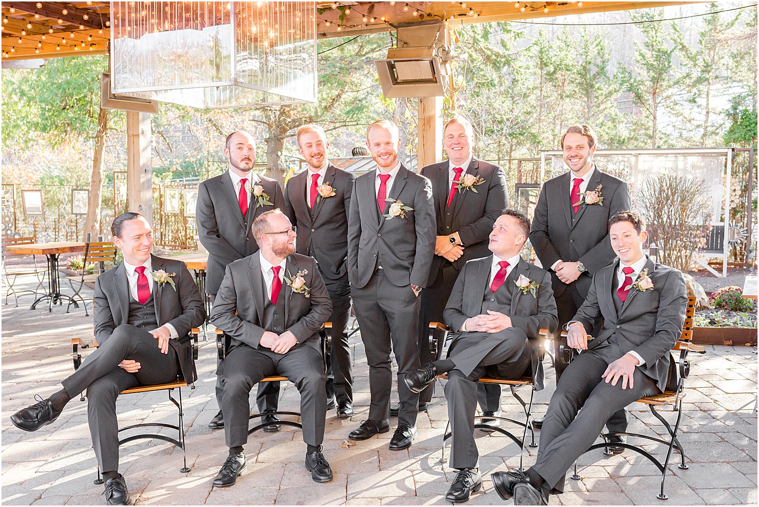 groom and groomsmen pose by fire pit at Stone House at Stirling Ridge