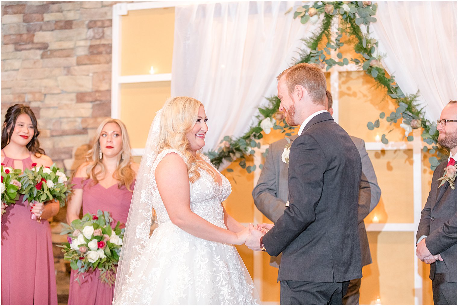 bride and groom smile together during NJ wedding ceremony