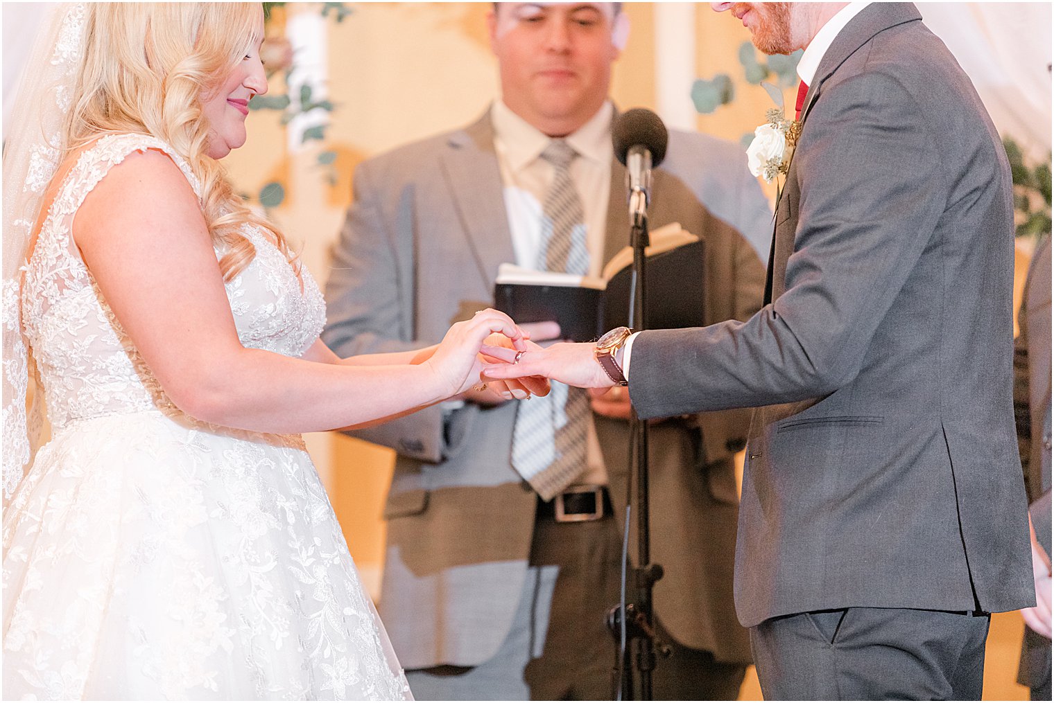 couple holds hands exchanging vows at the Stone House at Stirling Ridge