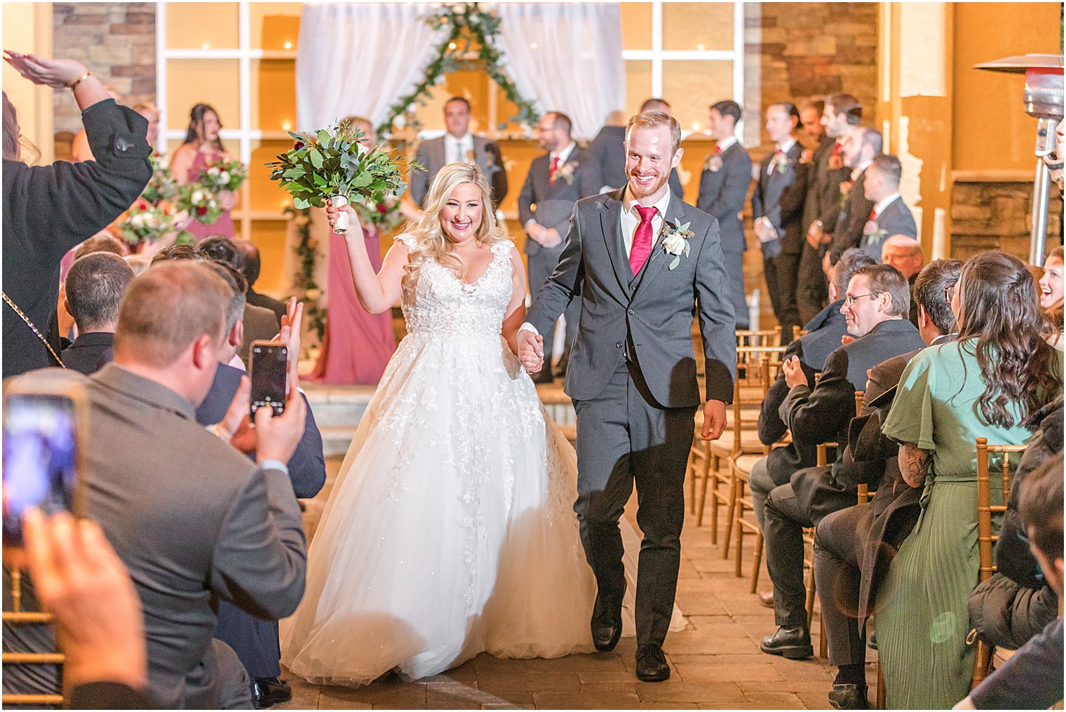 newlyweds walk up the aisle at the Stone House at Stirling Ridge