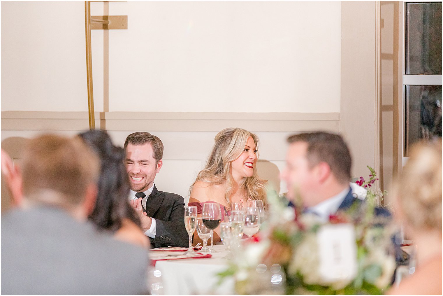 bride and groom laugh during speeches