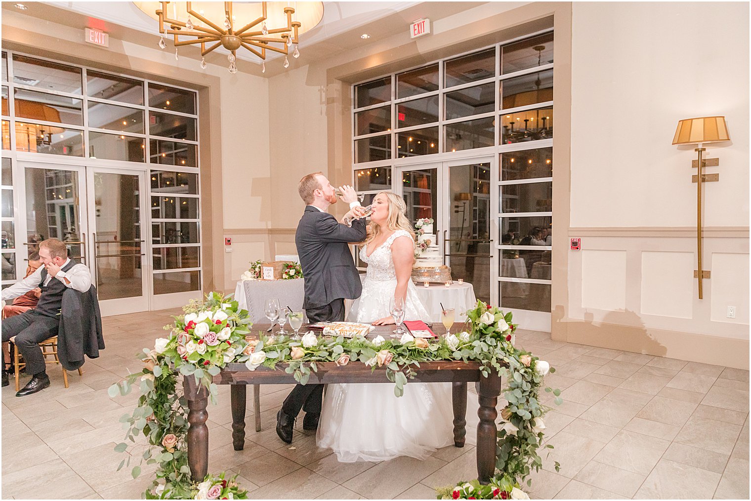 newlyweds toast with wine glasses intertwined