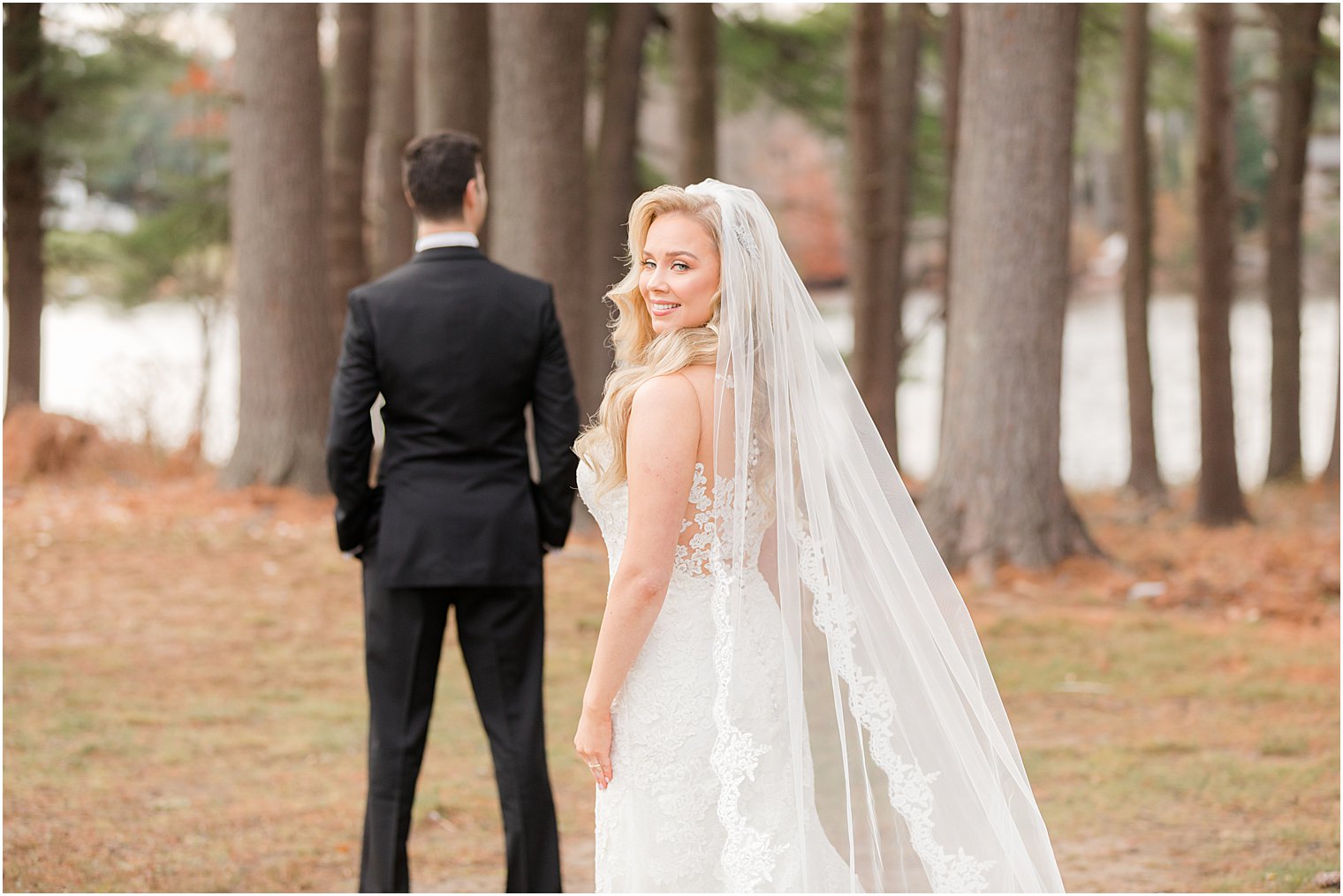bride approaches groom for first look during winter wedding