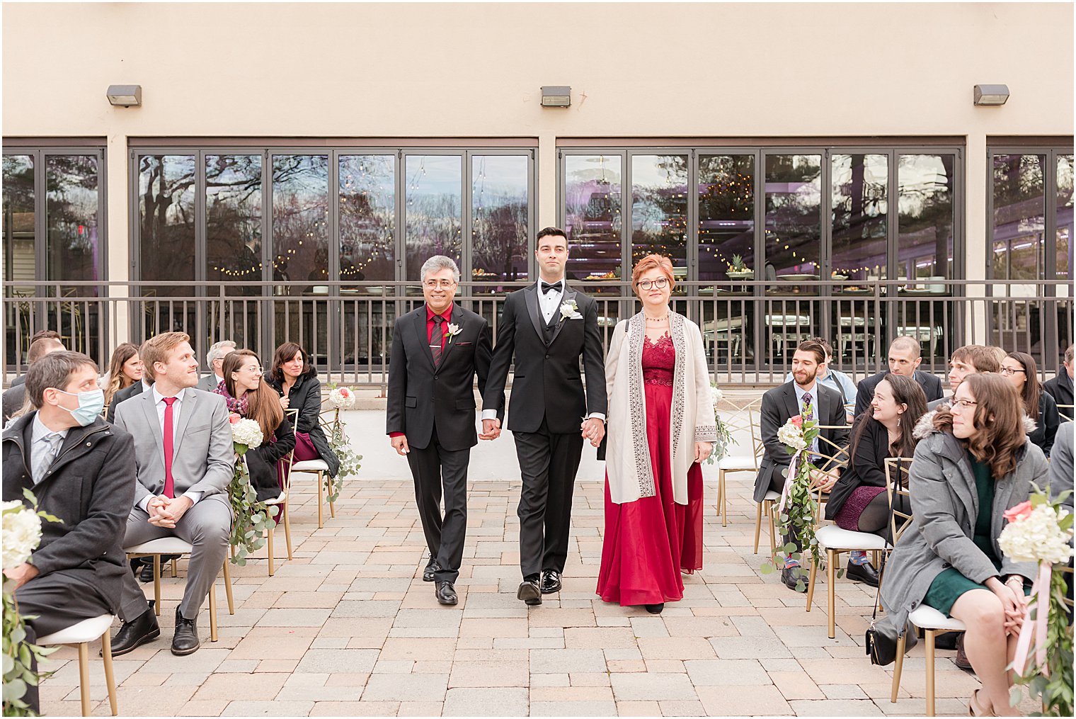groom walks down aisle with parents before outdoor wedding ceremony in East Brunswick NJ