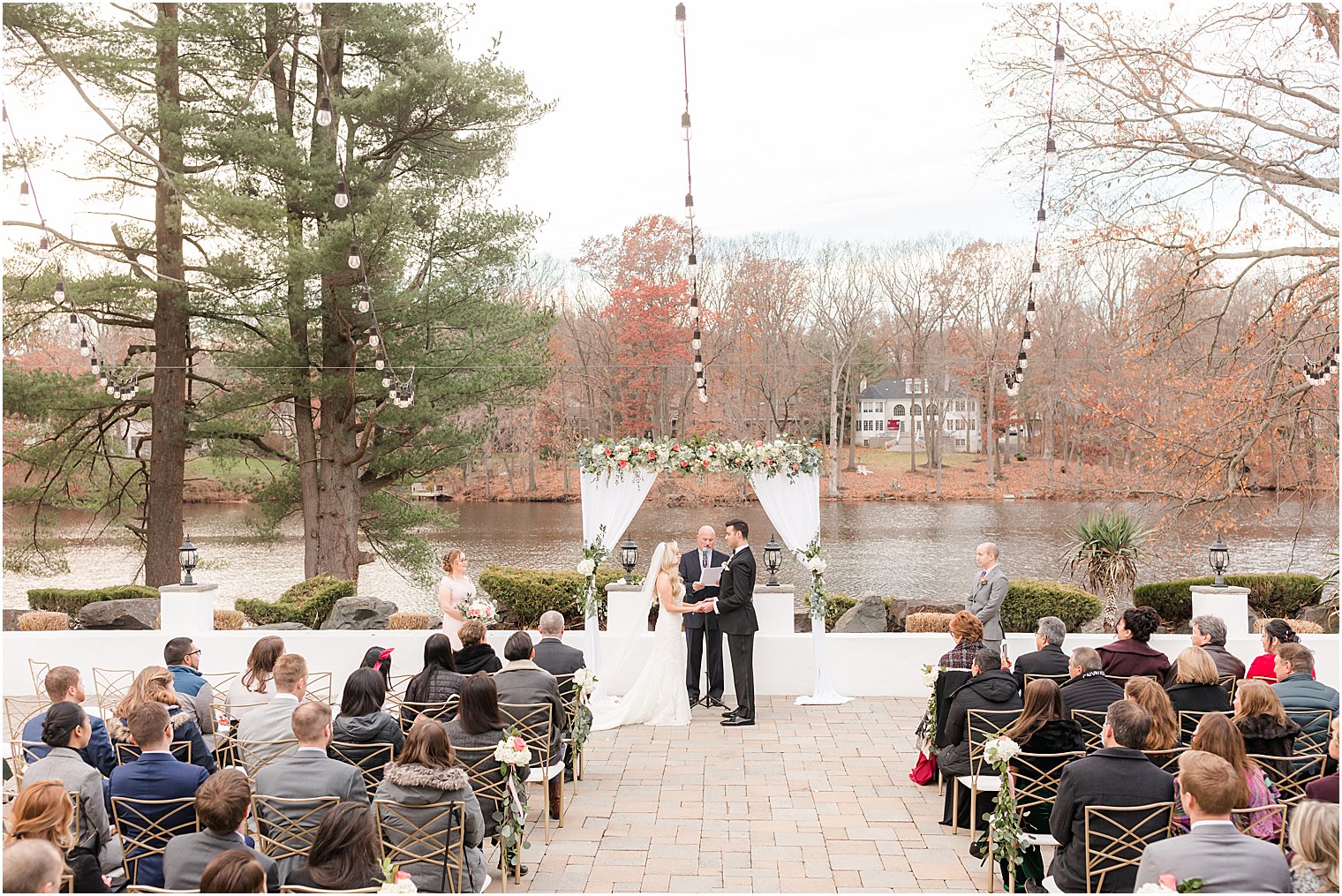 newlyweds hold hands exchanging vows during outdoor wedding ceremony in East Brunswick NJ