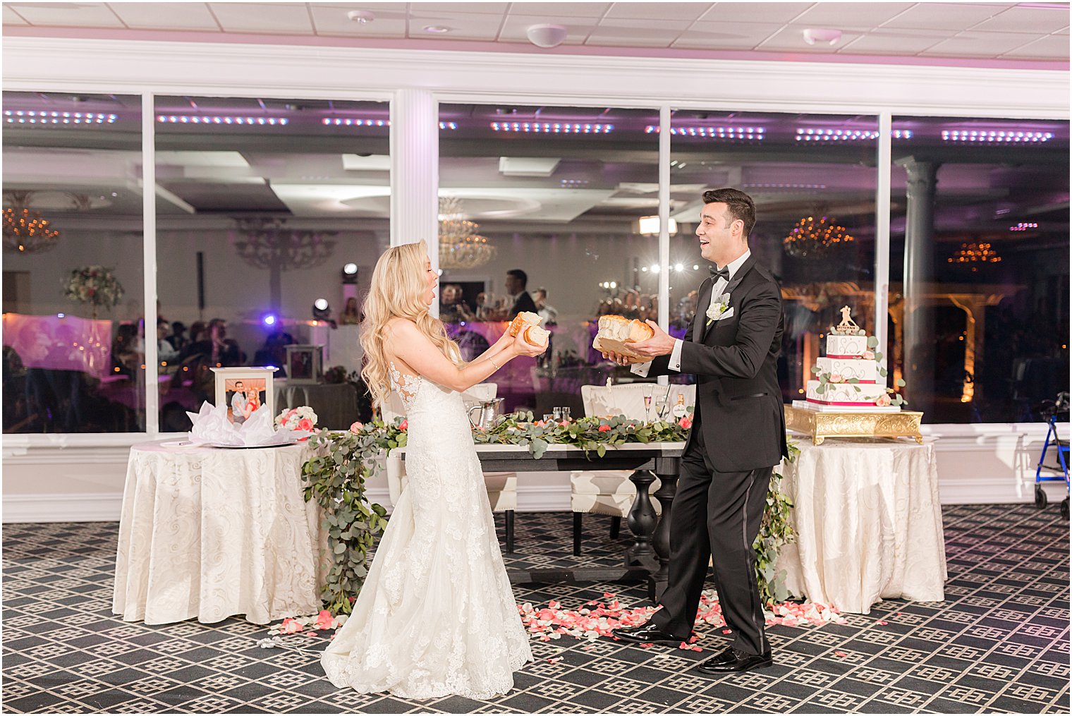 couple breaks bread during wedding reception at the Estate at Farrington Lake