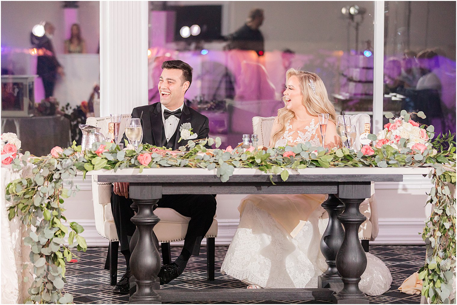 newlyweds laugh during toasts at NJ wedding reception 