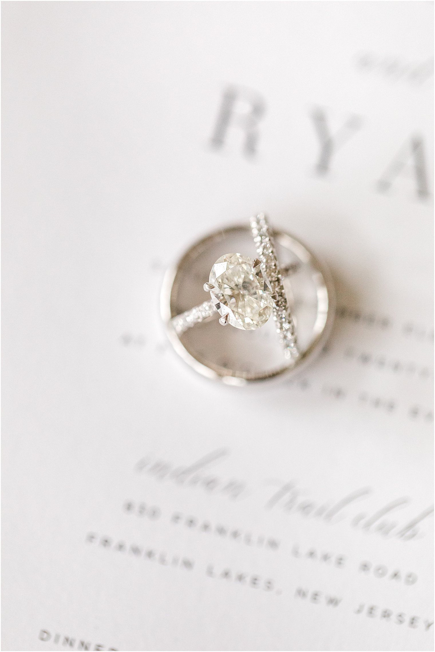 wedding rings lay on invitation 