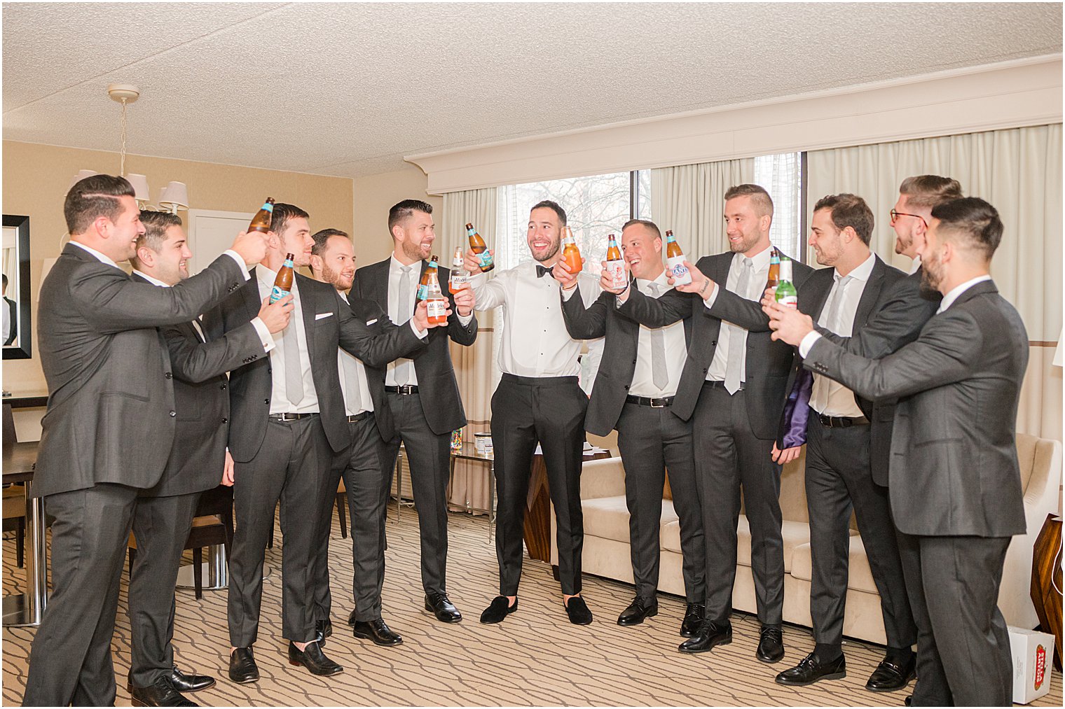groom toasts with groomsmen before Indian Trail Club wedding