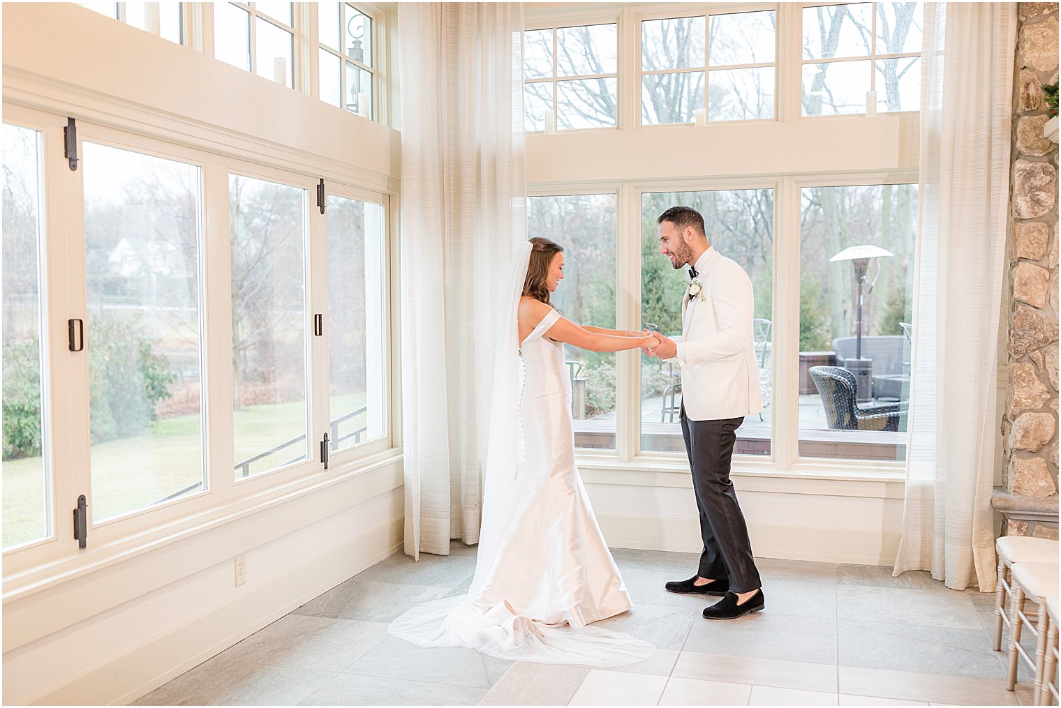 bride and groom look at each other during first look before NJ wedding