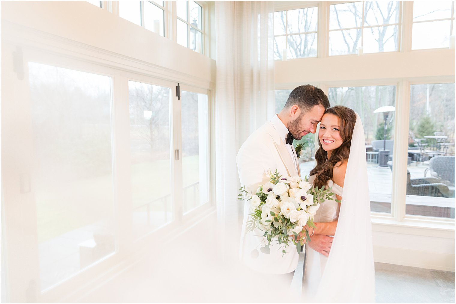 groom leans head against bride during Indian Trail Club wedding portraits