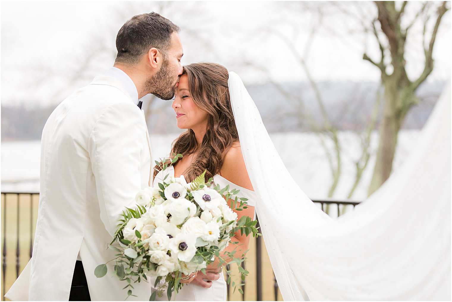 groom kisses bride's forehead in NJ