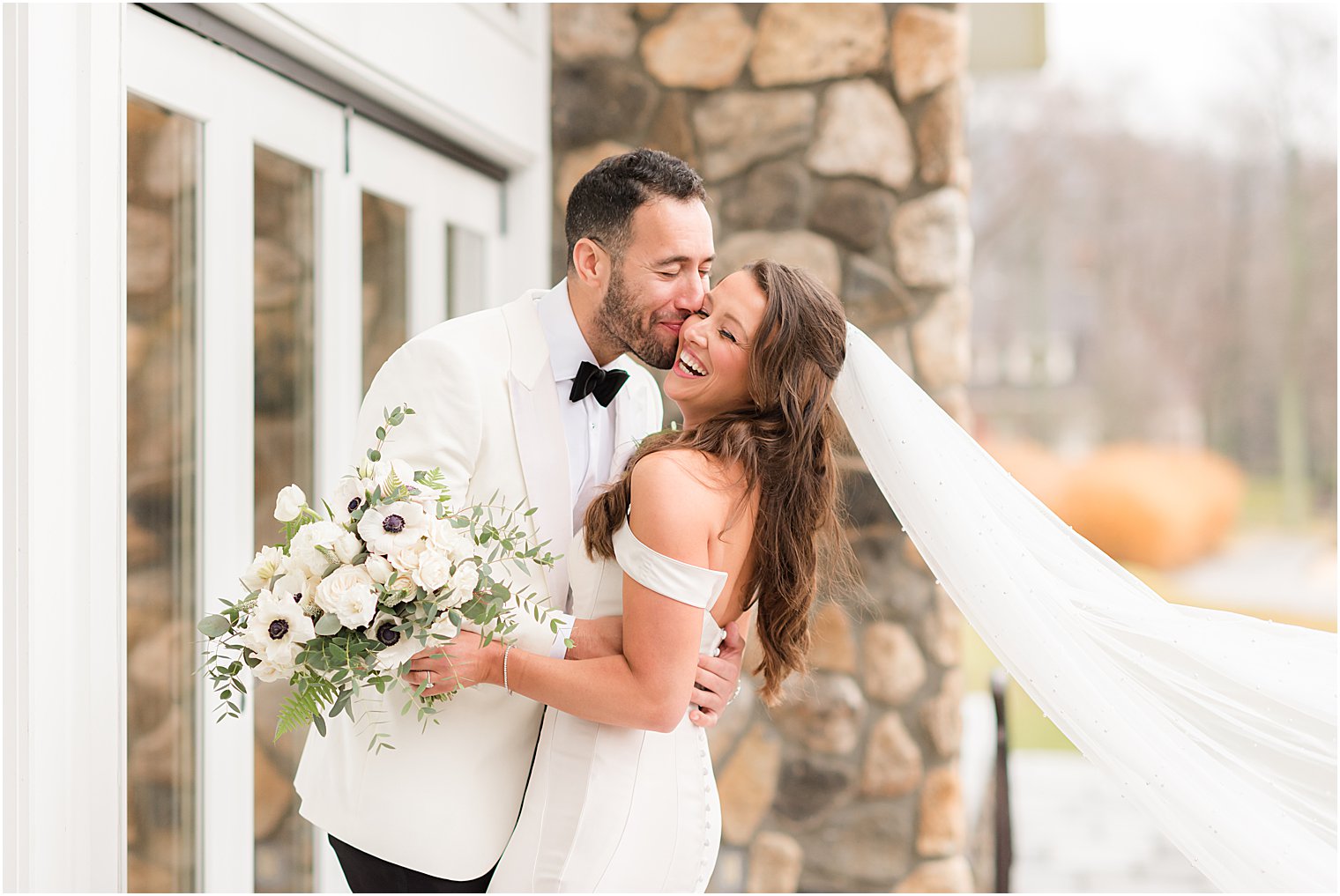 groom kisses bride's cheek