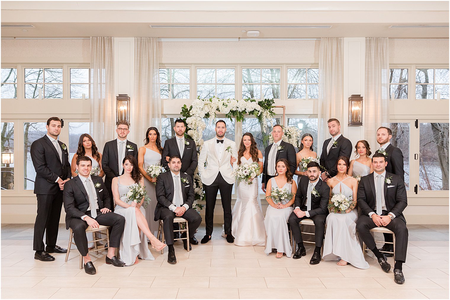 wedding party sits around bride and groom at Indian Trail Club