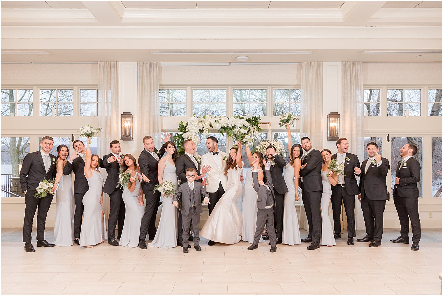 newlyweds cheer with wedding party at Indian Trail Club