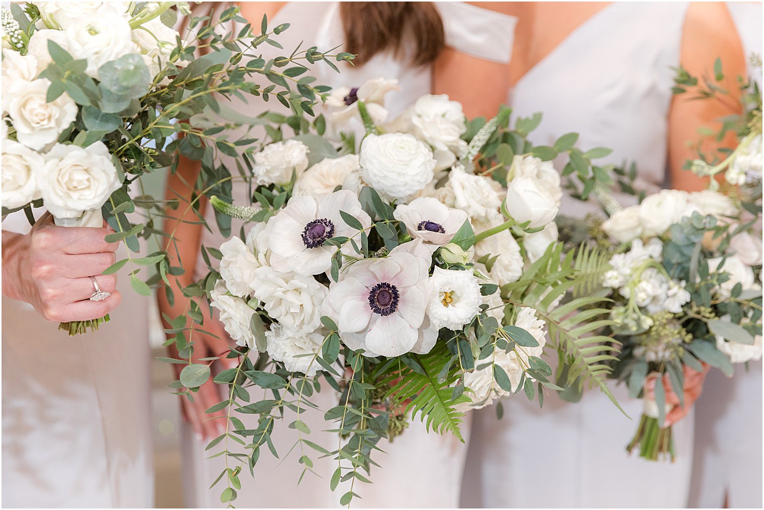 bridesmaids hold bouquet of greenery and light blue flowers