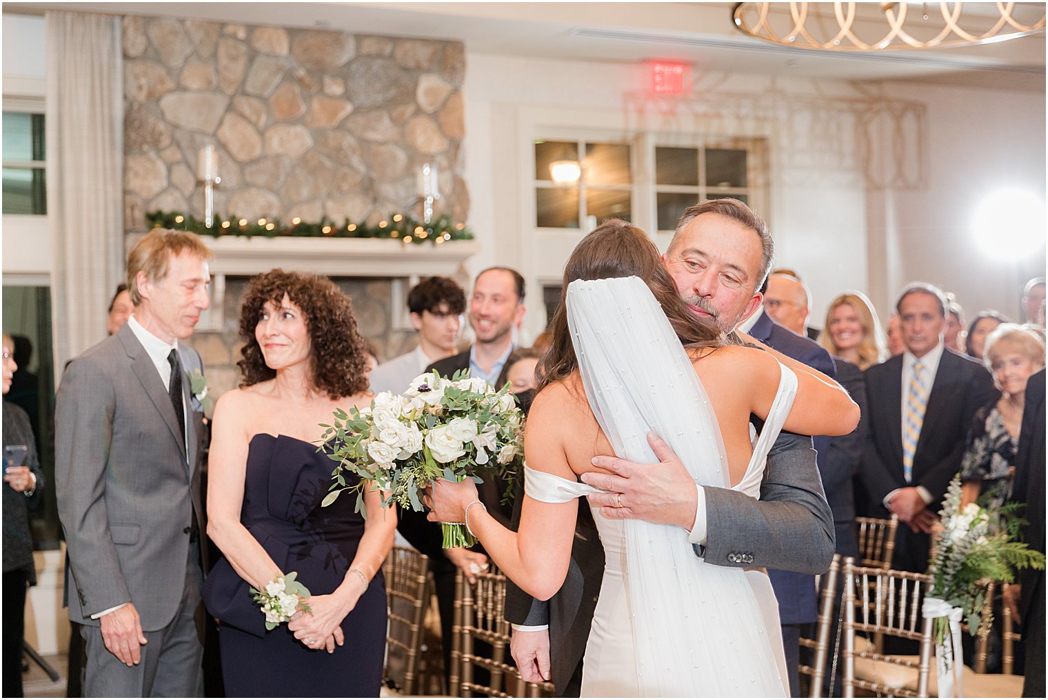 dad hugs bride during Jewish wedding ceremony in Franklin Lakes NJ