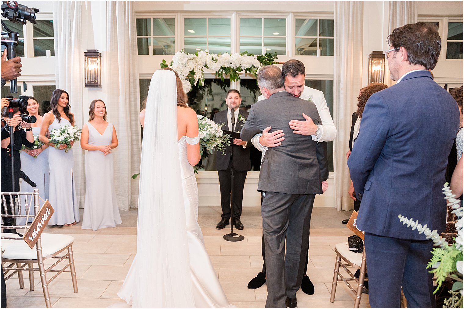 groom hugs bride's dad during winter wedding in New Jersey