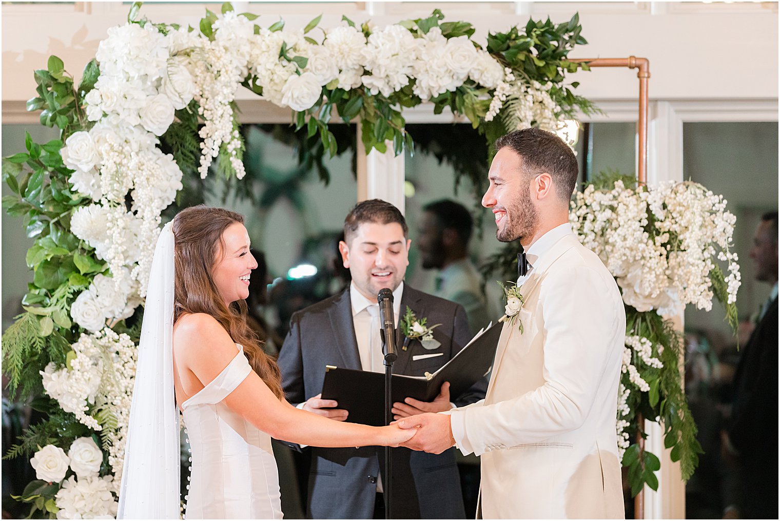 bride and groom exchange vows under canopy during Jewish wedding ceremony in Franklin Lakes NJ