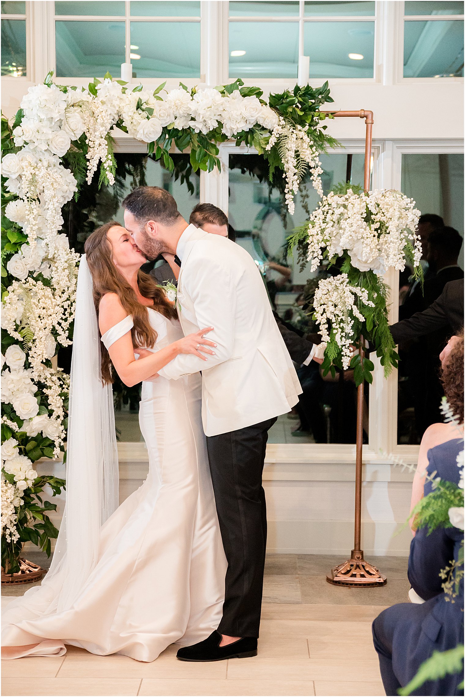 groom kisses bride during Jewish wedding ceremony in Franklin Lakes NJ