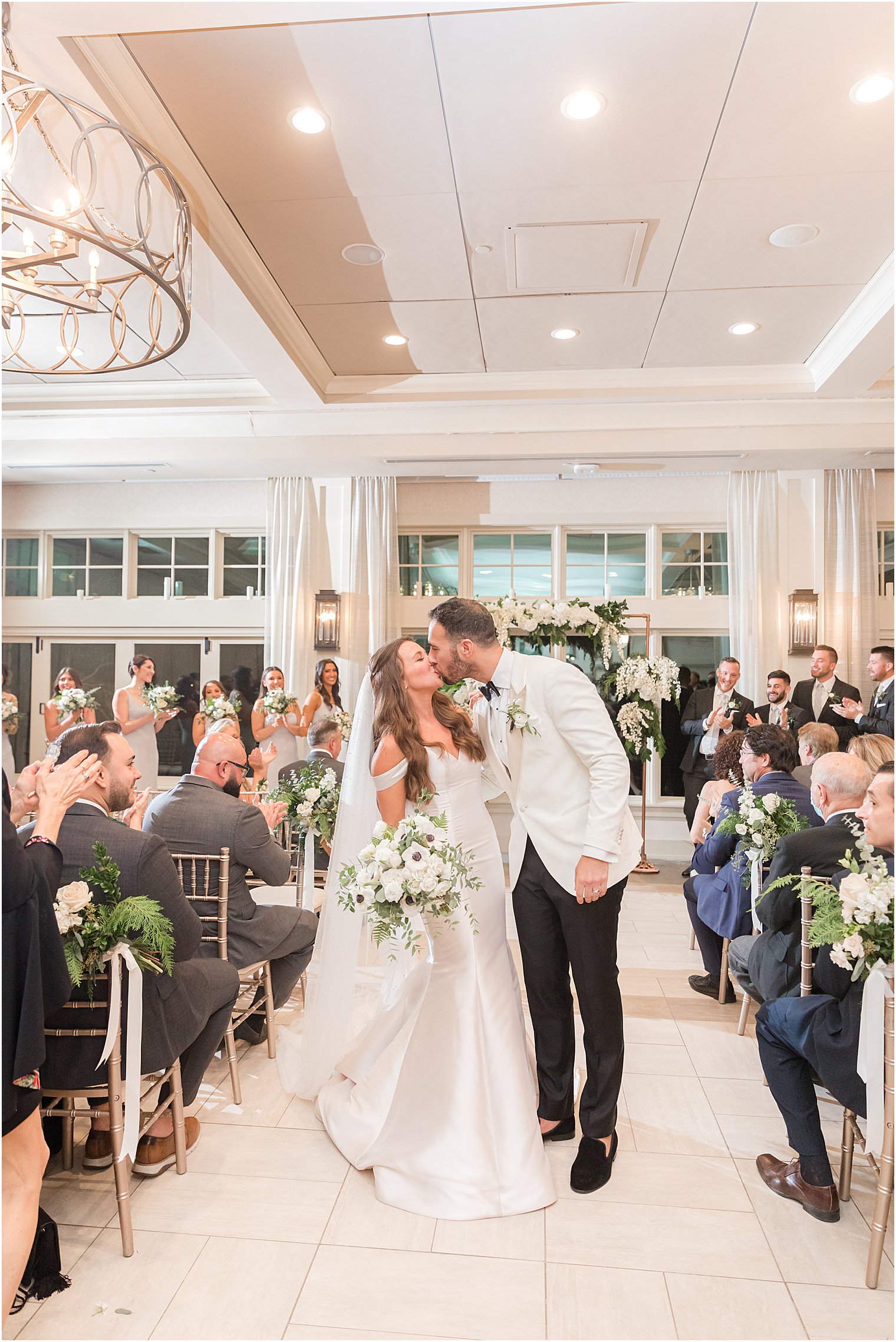 bride and groom kiss walking up aisle after Jewish wedding ceremony in Franklin Lakes NJ