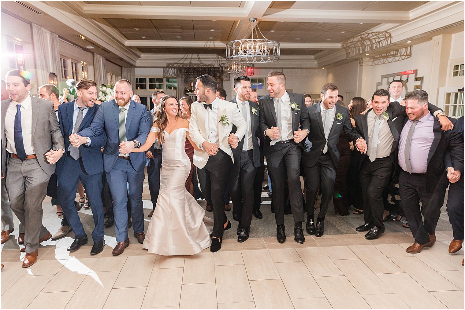 bride and groom dance hora with wedding guests