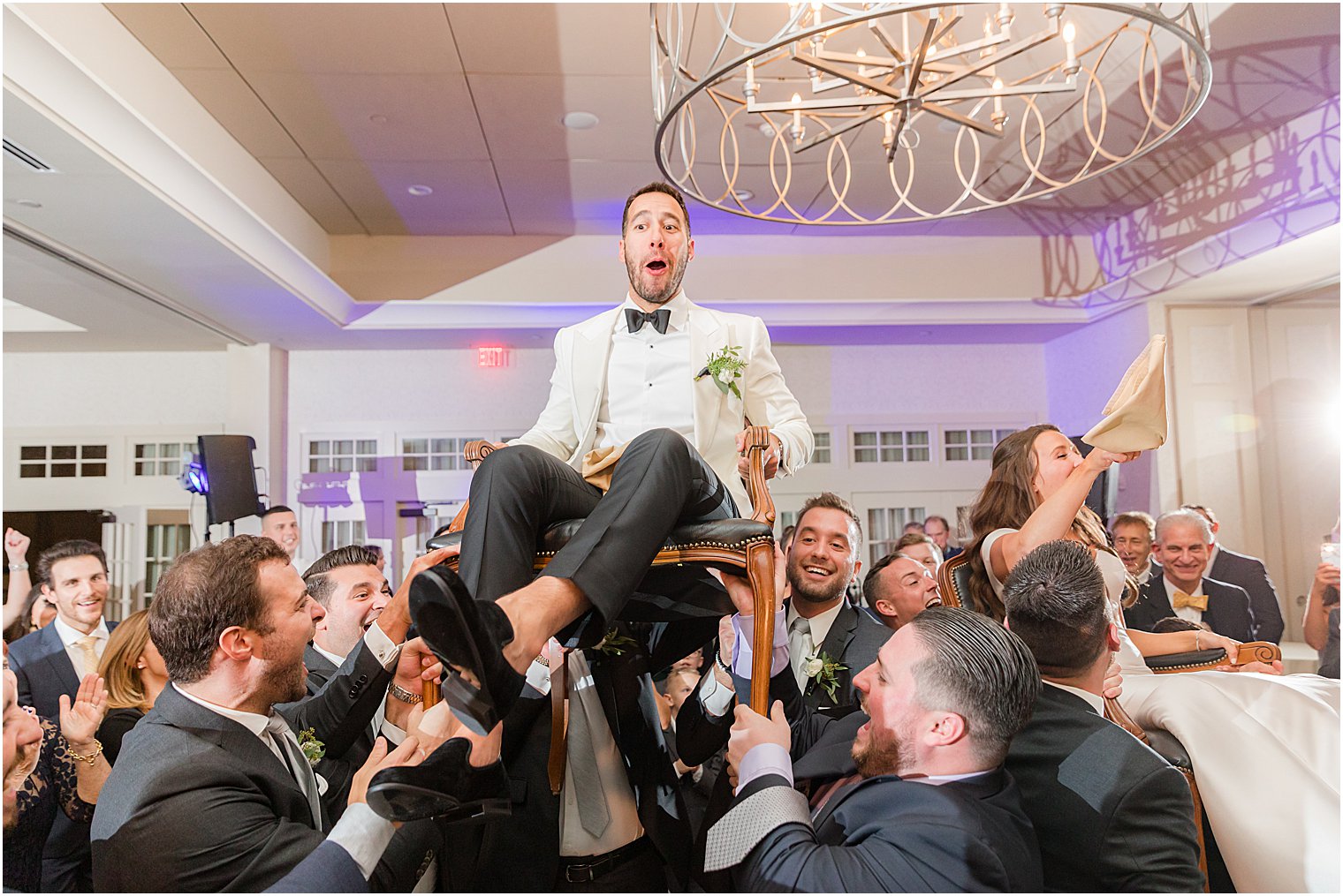 guests lift groom during hora at Indian Trail Club 