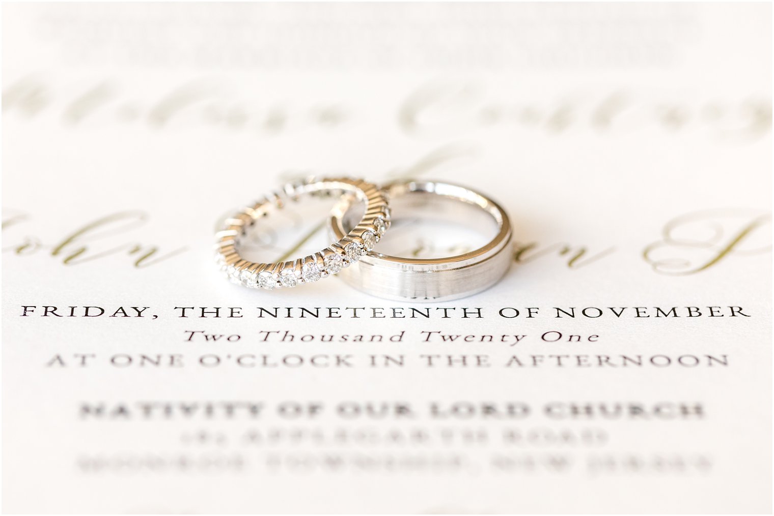 wedding bands rest on invitation suite for NJ wedding