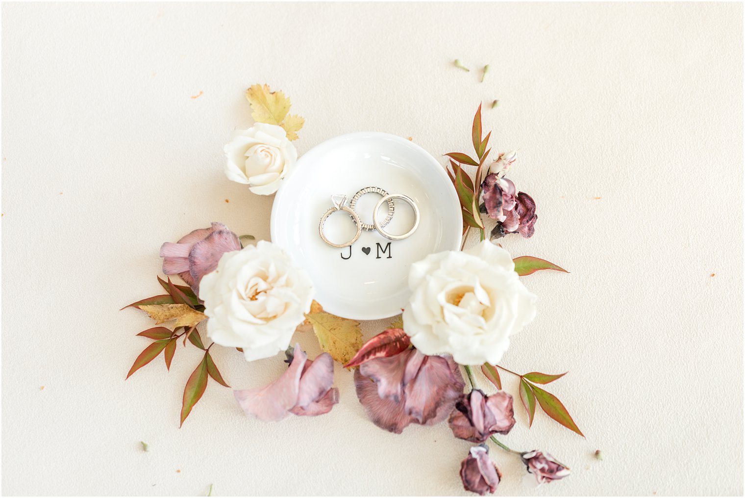 wedding rings rest in white ring plate for fall wedding 