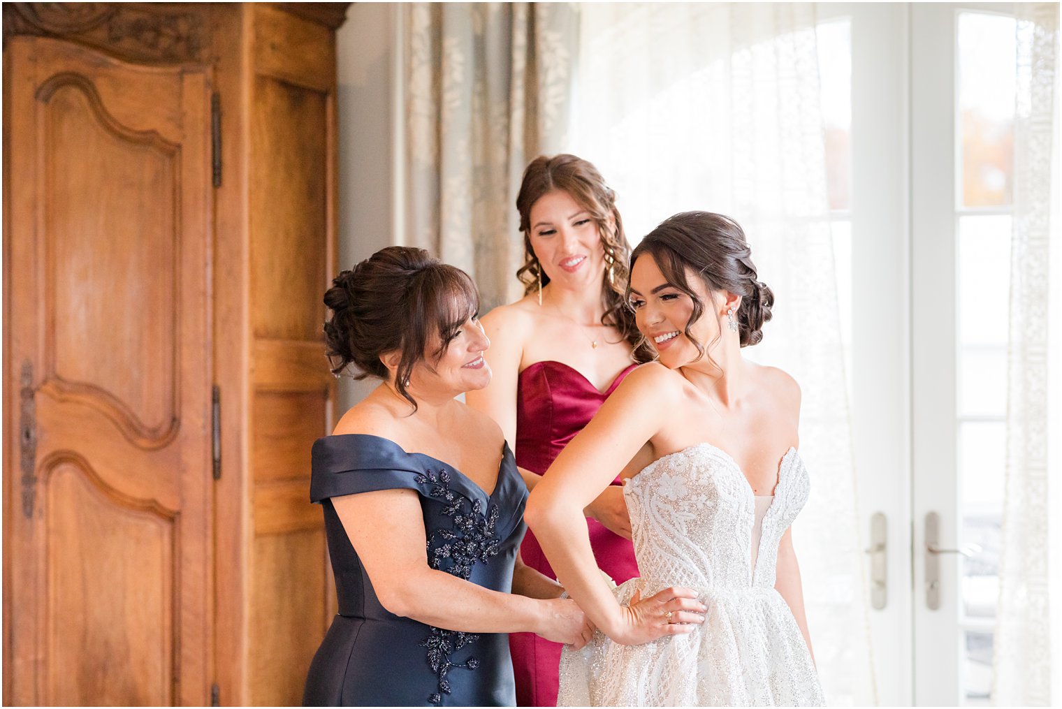 bride smiles at mother while preparing for fall wedding at Park Chateau Estate