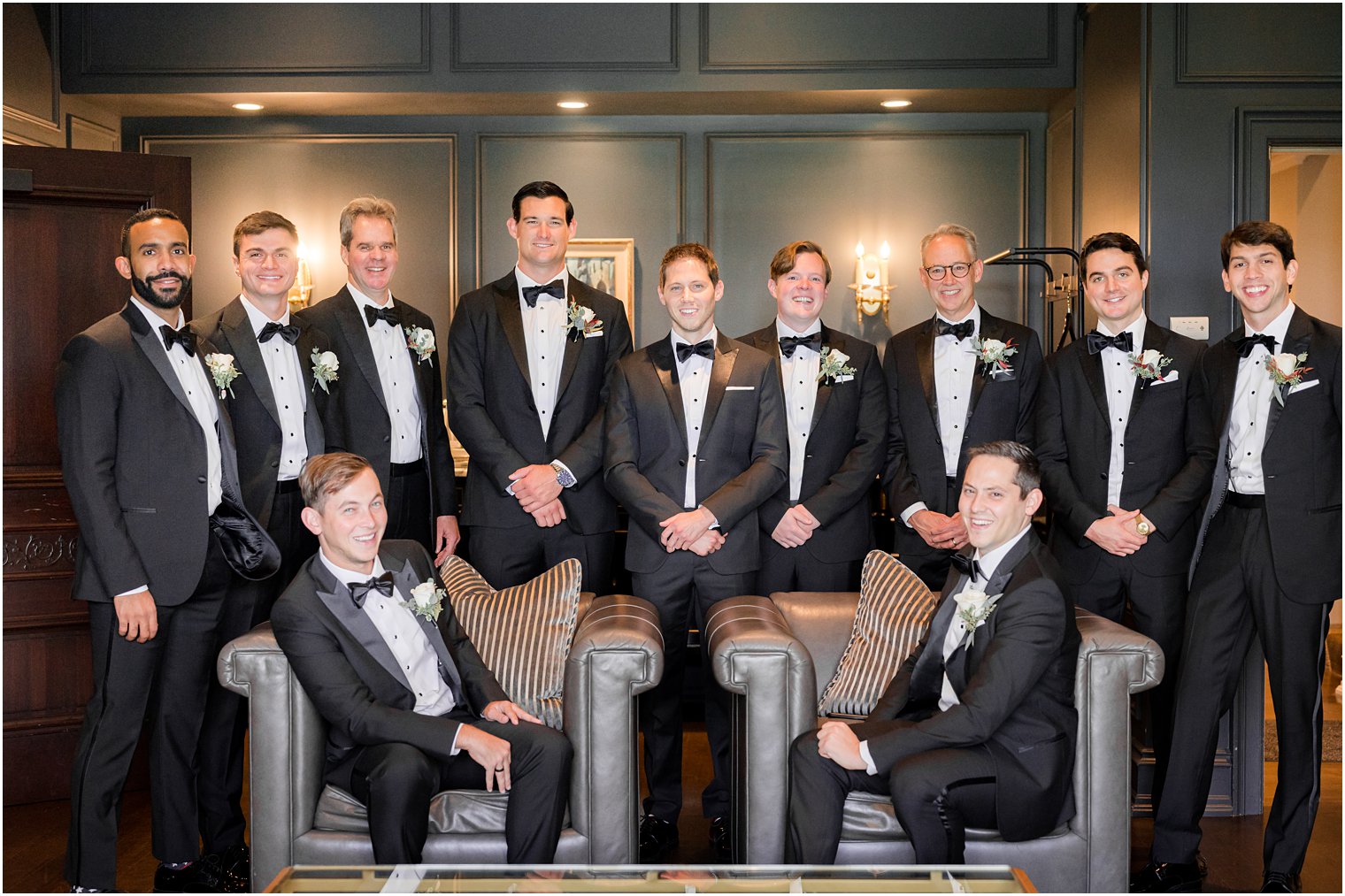 groom and groomsmen sit in drawing room at Park Chateau Estate