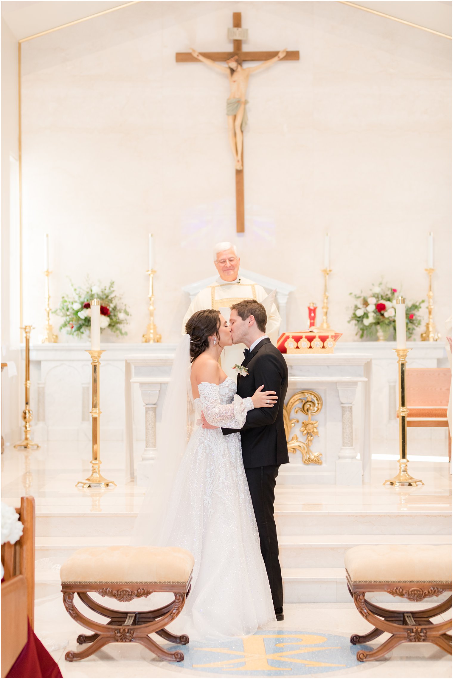 bride and groom kiss during NJ church wedding ceremony
