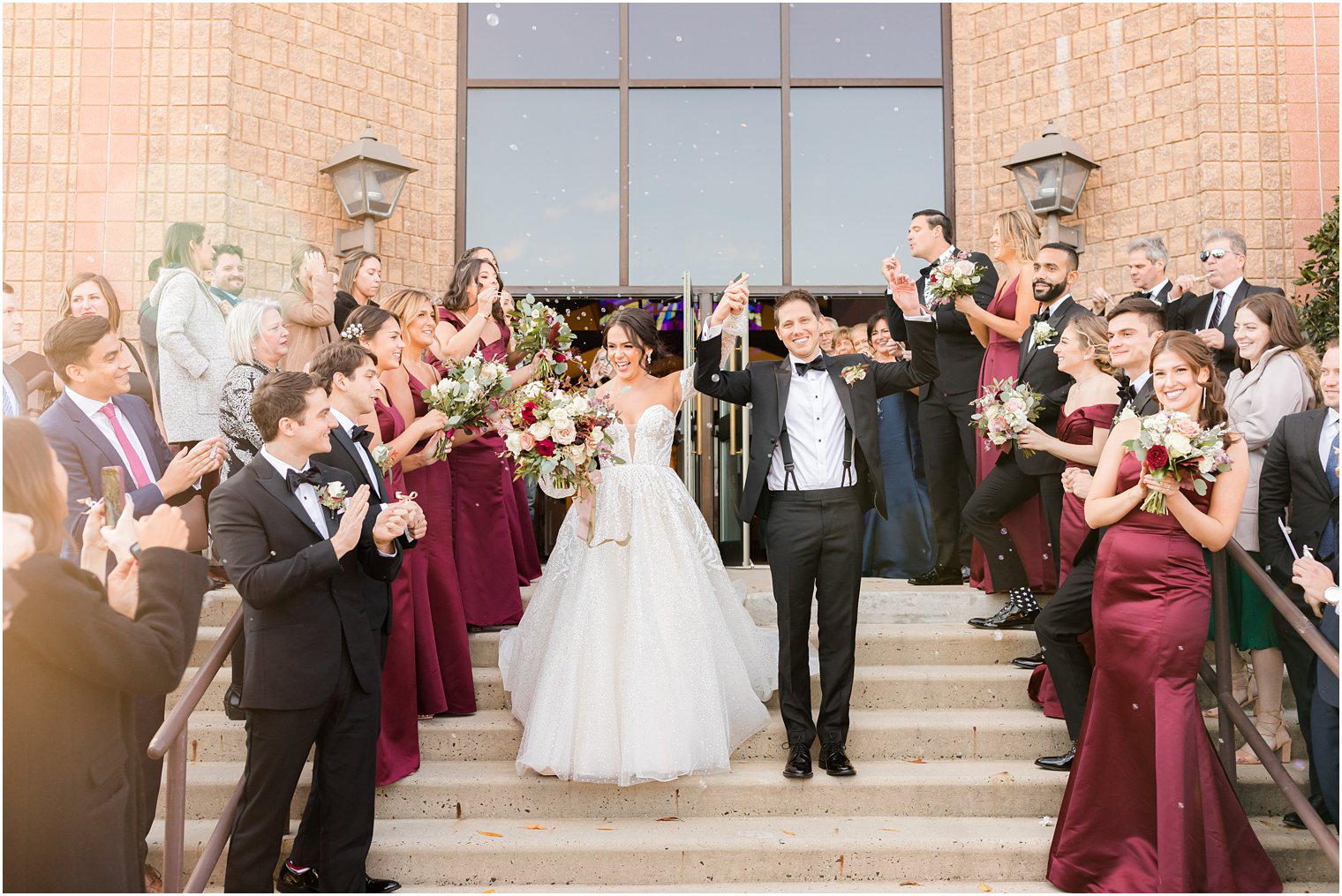 bride and groom leave wedding ceremony with bubbles