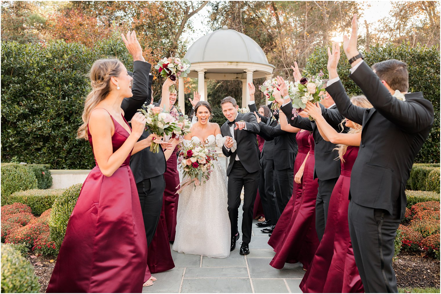couple walks through tunnel bridal party created at Park Chateau Estate