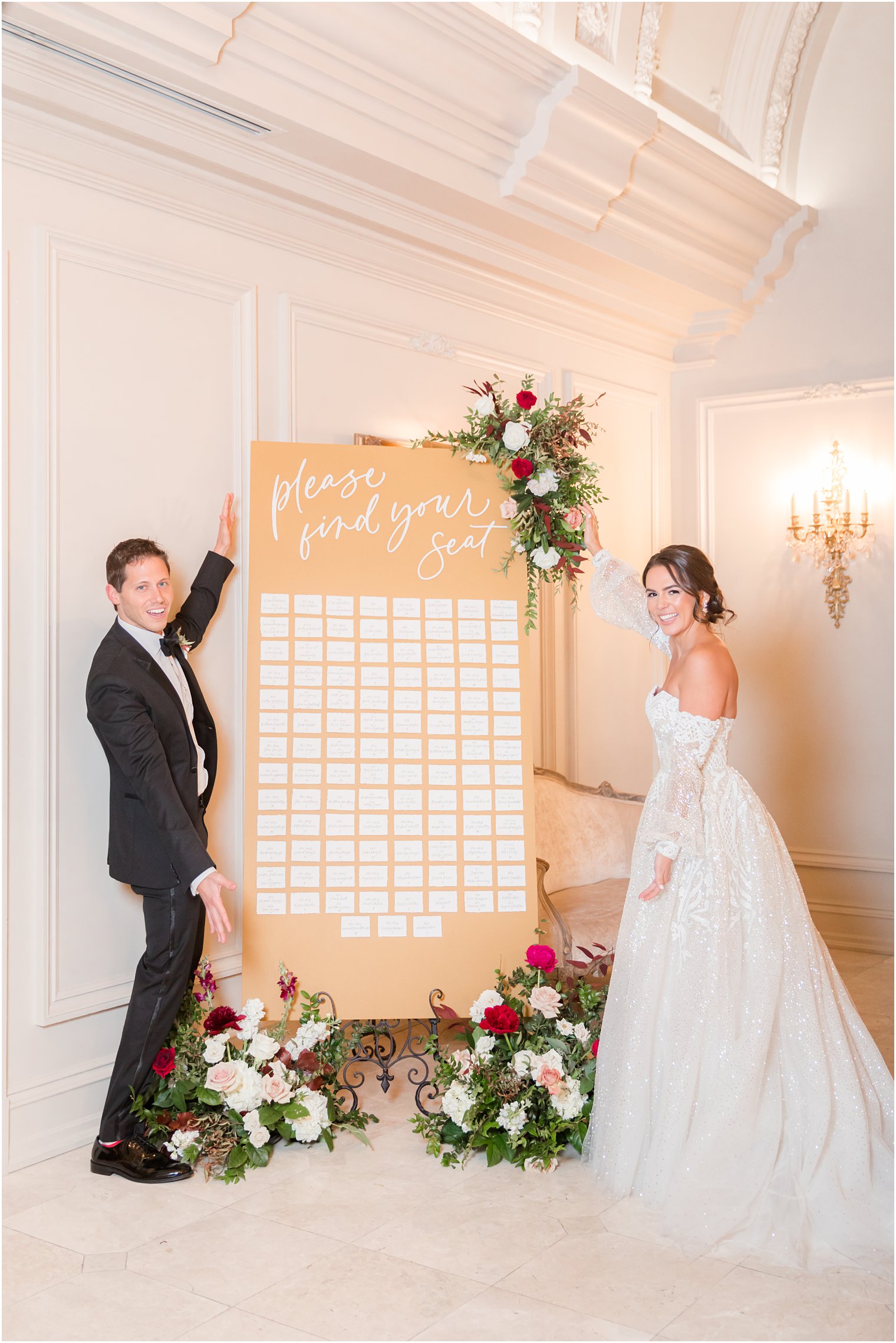 bride and groom show off gold back seating chart at Park Chateau Estate