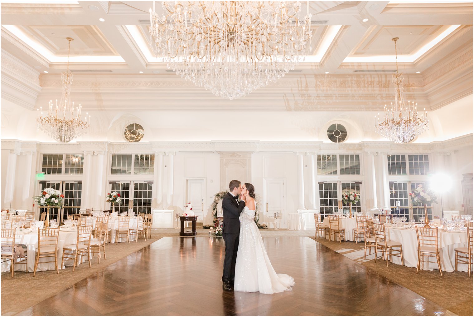bride and groom kiss in ballroom at Park Chateau Estate