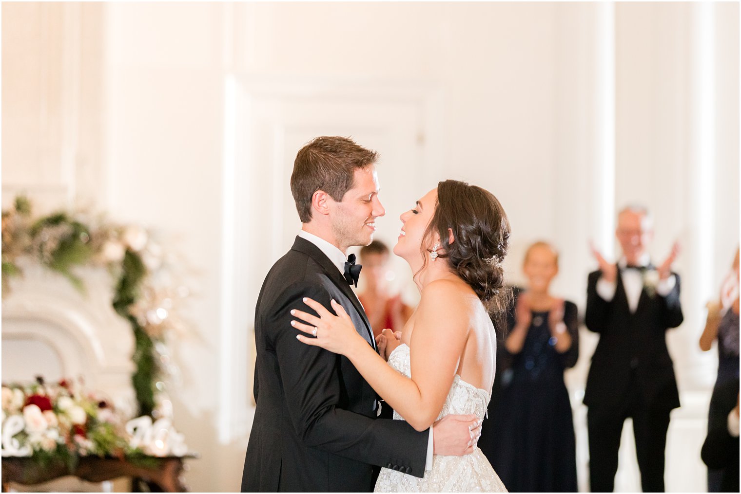 bride smiles at groom during first dance at East Brunswick NJ wedding reception