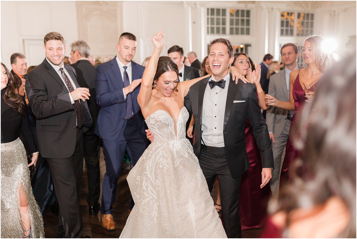 bride cheers during dancing at East Brunswick NJ wedding reception