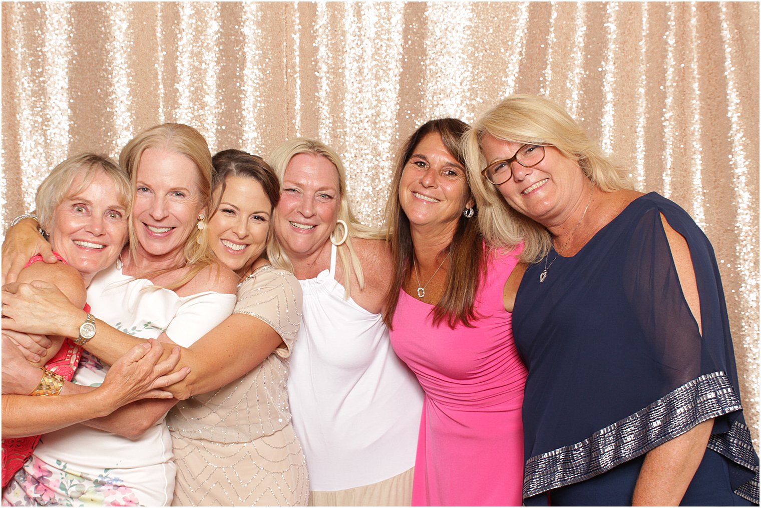 women hug during Indian Trail Club photo booth
