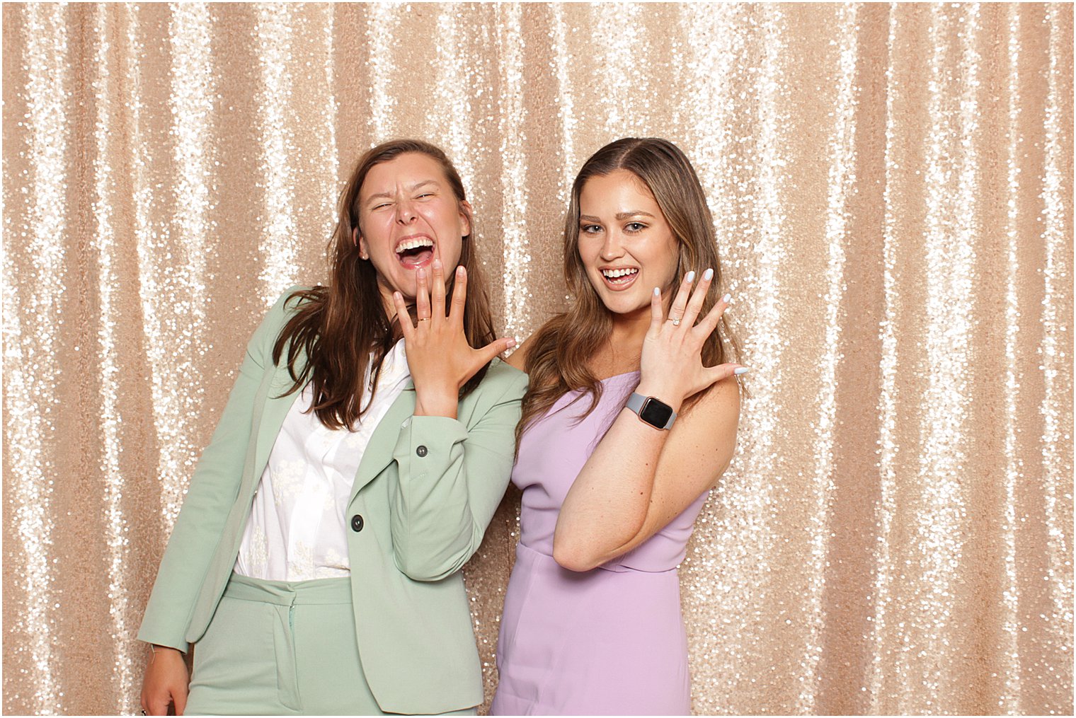 couple shows off wedding rings during Indian Trail Club photo booth
