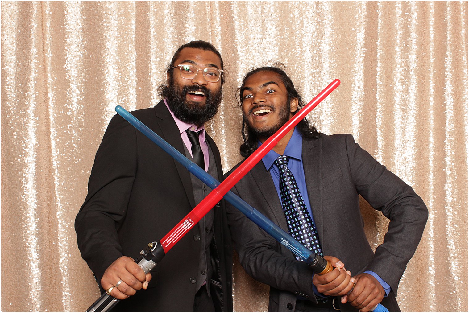 two men pose with light sabers in Indian Trail Club photo booth