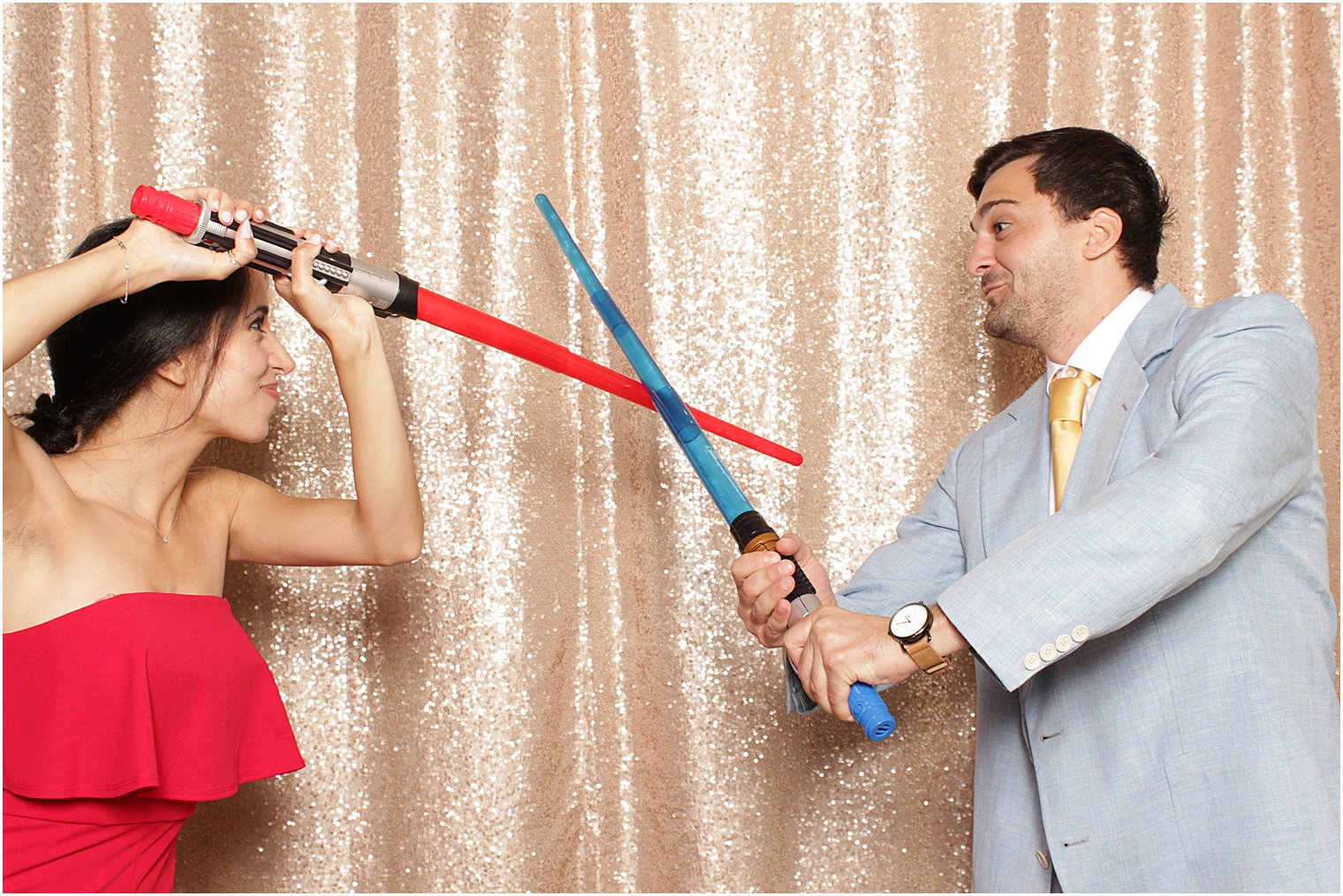 couple play fights with lightsabers during Indian Trail Club photo booth